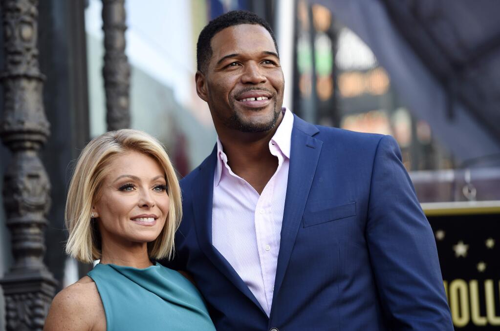 FILE - In this Oct. 12, 2015 file photo, Kelly Ripa, left, poses with Michael Strahan, her co-host on the daily television talk show 'LIVE! with Kelly and Michael,' during a ceremony honoring Ripa with a star on the Hollywood Walk of Fame in Los Angeles. Ripa returns as co-host of the morning show after a four-day absence after ABC announced Tuesday that co-host Strahan will leave the show to join 'Good Morning America' full-time. (Photo by Chris Pizzello/Invision/AP, File)