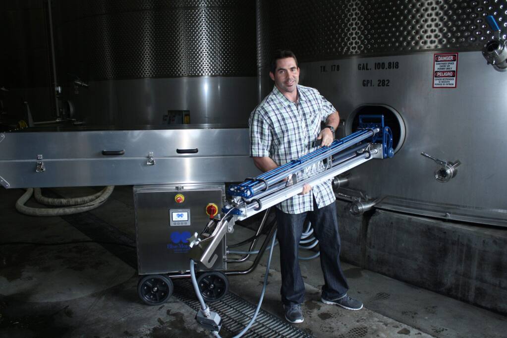 Alex Ferran, CEO and co-founder of BlueMorph, demonstrates his company's new ultraviolet light sanitation system for 100,000-gallon wine storage tanks at Jackson Family Wines in Santa Rosa on Sept. 16, 2015. This is said to be the first deployment of this technology in the wine industry. It's made by Tom Beard Company of Healdsburg. (GARY QUACKENBUSH / FOR NORTH BAY BUSINESS JOURNAL)