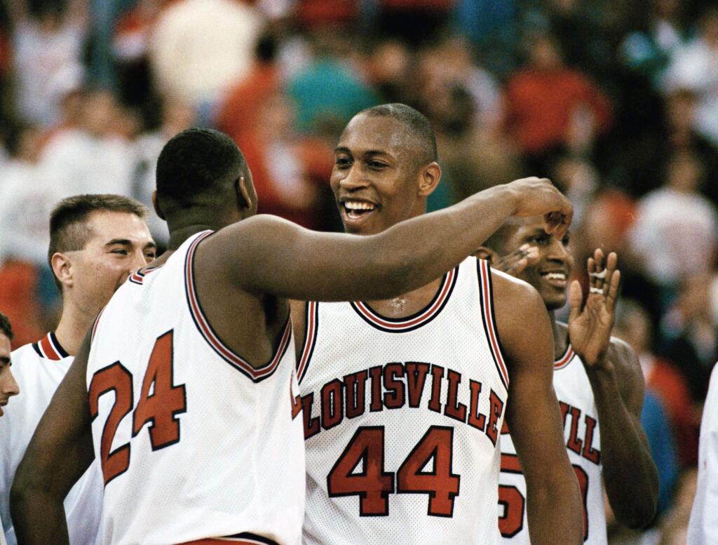 Clifford Rozier (44) celebrates Louisville's 78-63 victory against Oklahoma State with teammate Troy Smith (24) in the final minutes of their NCAA Midwest Regional second-round game in the Hoosier Dome in Indianapolis, Sunday, March 22, 1993. (AP Photo/Al Behrman)
