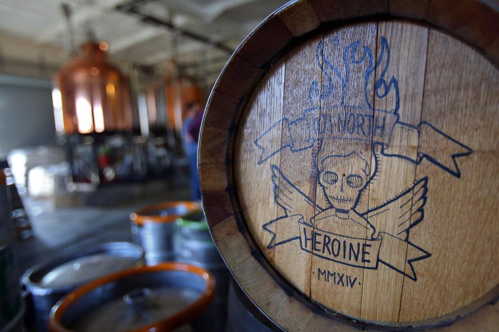 The 101 North Brewing Company Heroine logo is emblazoned on the side of a barrel at their Petaluma brewing facility.(Christopher Chung/ The Press Democrat)