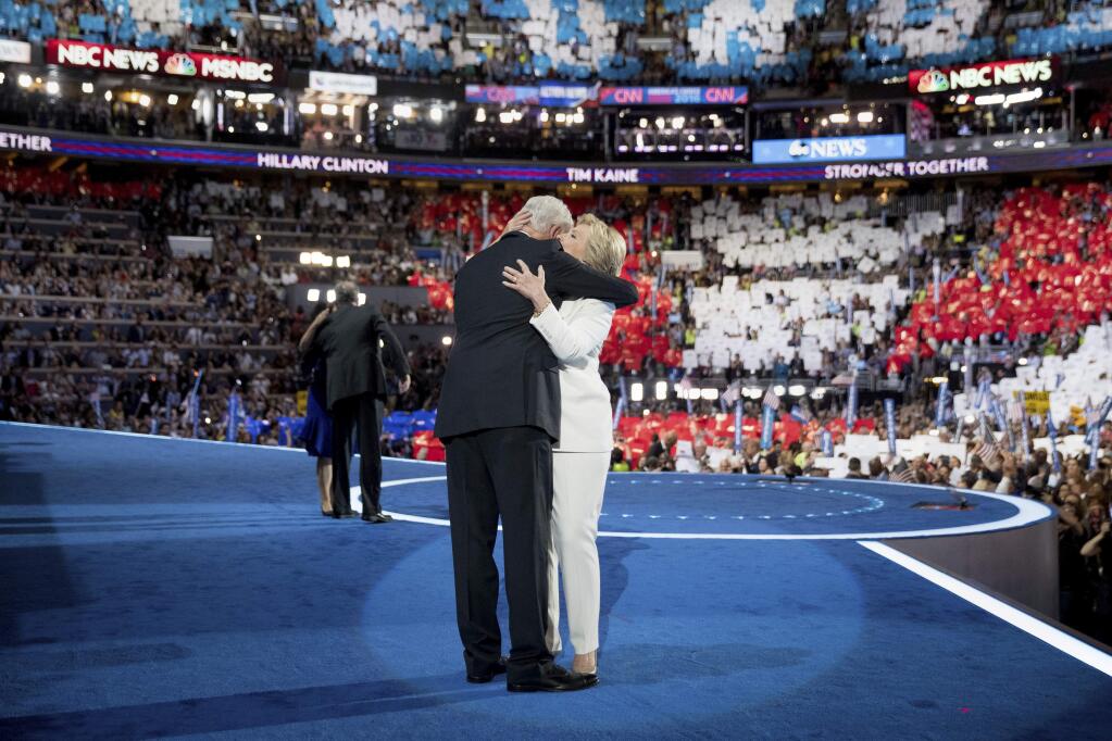 Former President Bill Clinton hugs Democratic presidential candidate Hillary Clinton, right, as he joins her on stage during the fourth day session of the Democratic National Convention in Philadelphia, Thursday, July 28, 2016. (AP Photo/Andrew Harnik)