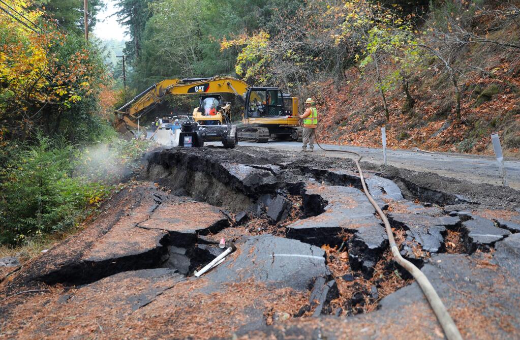 A construction crew works on repairing a section of Coleman Valley Road that was damaged during last winter's storms, near Occidental on Wednesday, November 13, 2019. (Christopher Chung/ The Press Democrat)