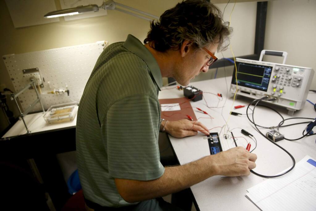 Dr. Patrick Rousche, CEO of Hemotek, sets up a test circuit at their offices in Rohnert Park on Thursday, Sept. 11, 2014. (BETH SCHLANKER / The Press Democrat)