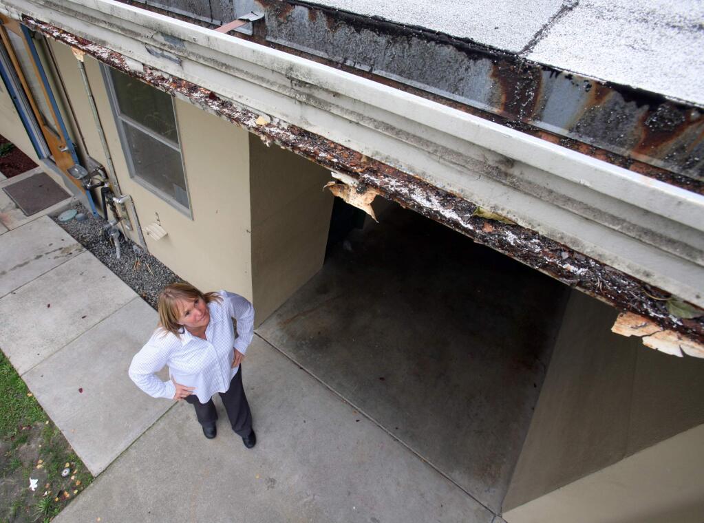 Superintendant/Principal Tracie Kern looks up at the old roof and gutters that have rusted through at Cinnabor Elm. School on Tuesday October 14, 2014.