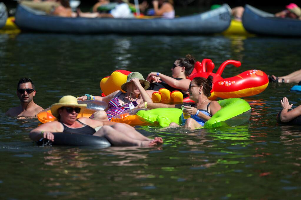 Music lovers beat the heat floating in the water at Johnson's Beach in Guerneville at the Russian River Jazz & Blues Festival on Saturday, Sept. 9, 2017. (JOHN BURGESS/ PD)
