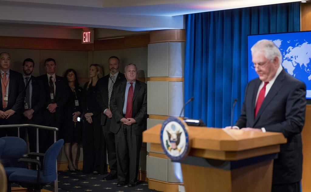 Staff members including Deputy Secretary of State John Sullivan, second from right, watches as Secretary of State Rex Tillerson speaks at a news conference at the State Department in Washington, Tuesday, March 13, 2018. President Donald Trump fired Tillerson and said he would nominate CIA Director Mike Pompeo to replace him, in a major staff reshuffle just as Trump dives into high-stakes talks with North Korea. Tillerson announced that Sullivan would take over all of his responsibilities starting today. (AP Photo/Andrew Harnik)