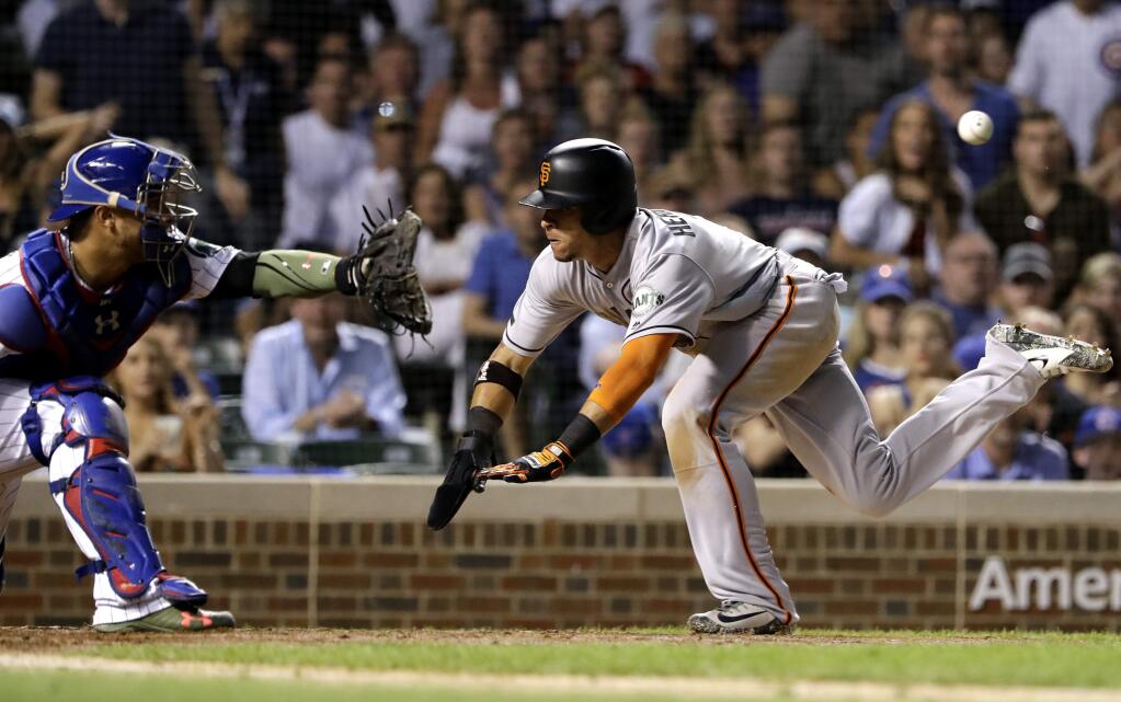 The San Francisco Giants' Gorkys Hernandez, right, scores on a sacrifice fly by Brandon Belt as Chicago Cubs catcher Willson Contreras waits for the ball during the seventh inning in Chicago, Saturday, May 26, 2018. (AP Photo/Nam Y. Huh)