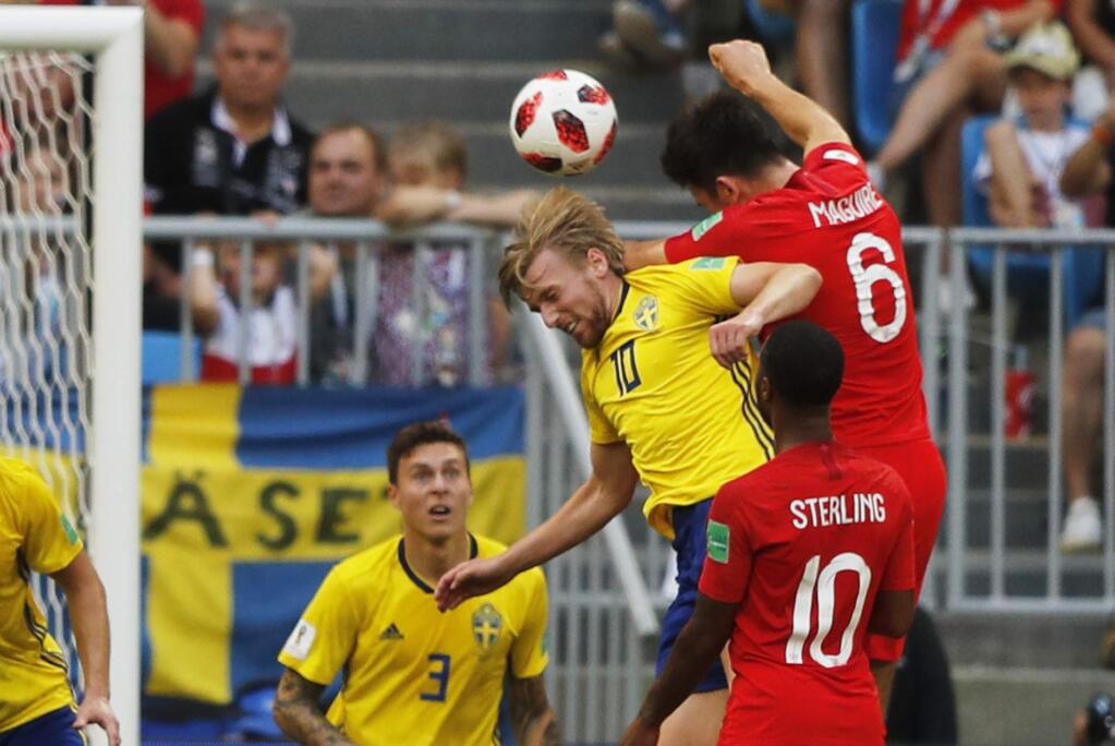 England's Harry Maguire, right above, scores his side's opening goal during the quarterfinal match between Sweden and England at the 2018 soccer World Cup in the Samara Arena, in Samara, Russia, Saturday, July 7, 2018. (AP Photo/Frank Augstein)