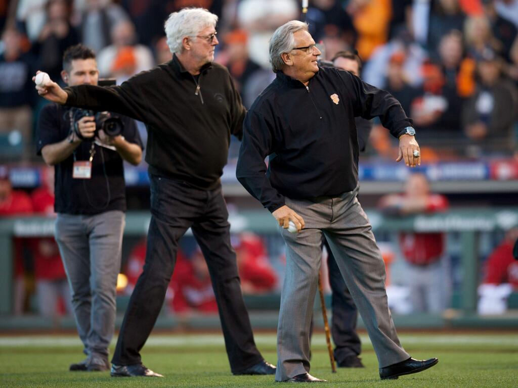 Giants broadcasters Mike Krukow and Duane Kuiper throw out the first pitch before an NLDS playoff game between the San Francisco Giants and Washington Nationals on Oct. 7, 2014, at AT&T Park in San Francisco. (Icon Sportswire via AP Images)