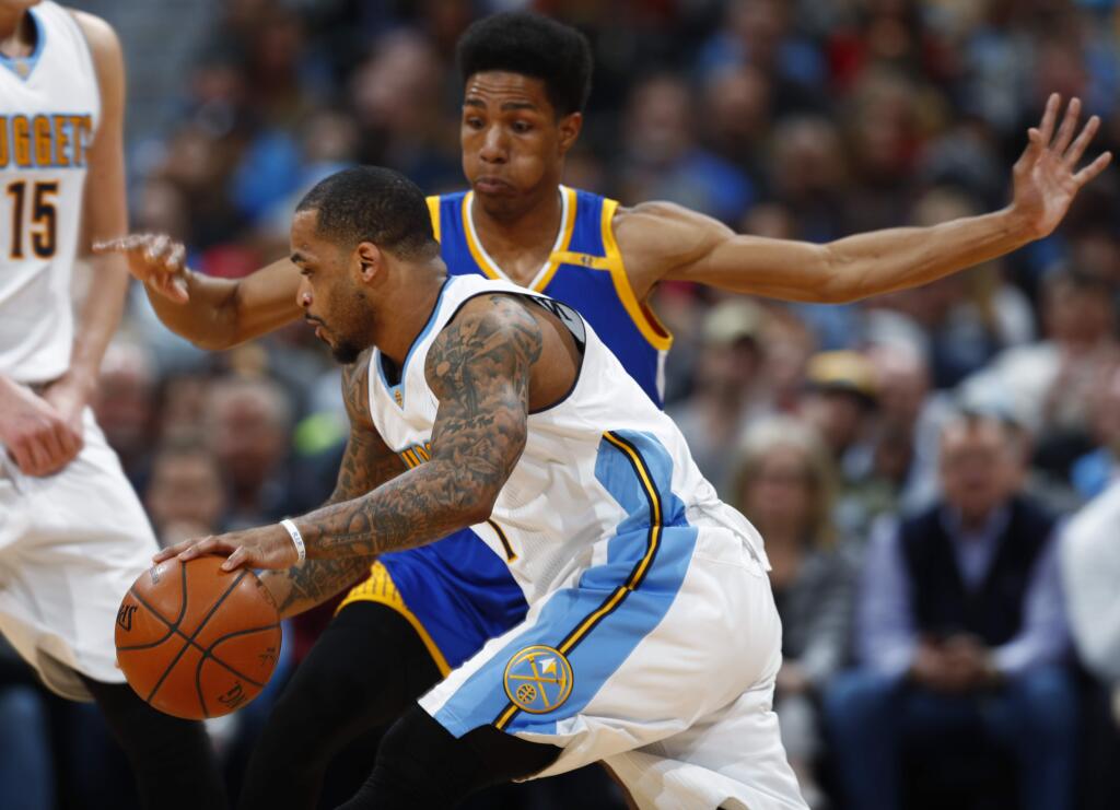 Denver Nuggets guard Jameer Nelson, front, drives the lane as Golden State Warriors guard Patrick McCaw defends in the first half of an NBA basketball game Monday, Feb. 13, 201, in Denver. (AP Photo/David Zalubowski)
