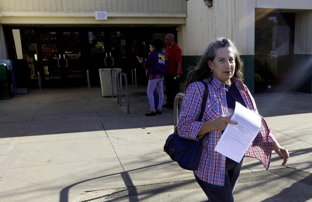Grace Stratman leaves the Department of Motor Vehicles after she was unable to get her drivers license renewed due to a computer failure, in Carmichael, Calif., Wednesday, Oct. 26, 2016. The Department of Motor Vehicles says a catastrophic computer failure is hampering operations at more than 100 field offices. The outage began Monday affecting offices around the state. (AP Photo/Rich Pedroncelli)