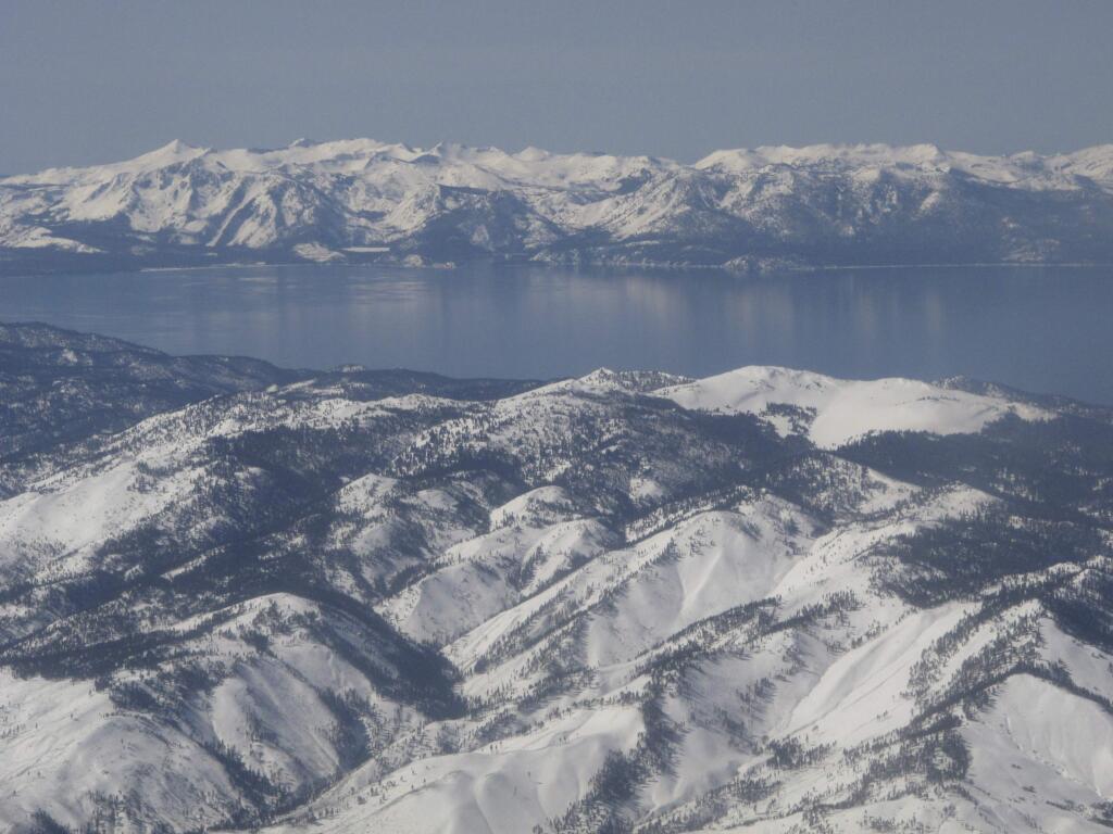 Scientists say water clarity has rebounded from an all-time low in 2017 at Lake Tahoe, pictured in this photo taken from an airplane departing from Reno, Nev. on March 2, 2017. UC Davis researches said on Thursday, May 23, 2019 that Last year's reading improved about 10 feet from the previous year and is now in line with the most recent five-year average. (AP Photo/Scott Sonner)