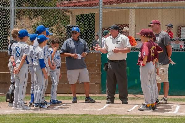 Major League Umpire Don DeJong reviews the rules with managers and players of Petersen's Paints and McNear's before the game at Carter Field's Petaluma on Saturday, June 20, 2015. (JOHN O'HAIRE/FOR THE ARGUS COURIER)