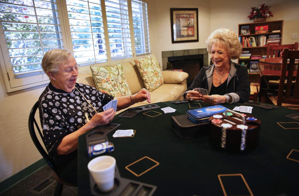 Jeanne Sharp, left, and Teddy Asivido play a hand of Go Fish at the Salvation Army Santa Rosa Corps Senior Activities Center, in Santa Rosa on Tuesday, May 23, 2017. (Christopher Chung/ The Press Democrat)