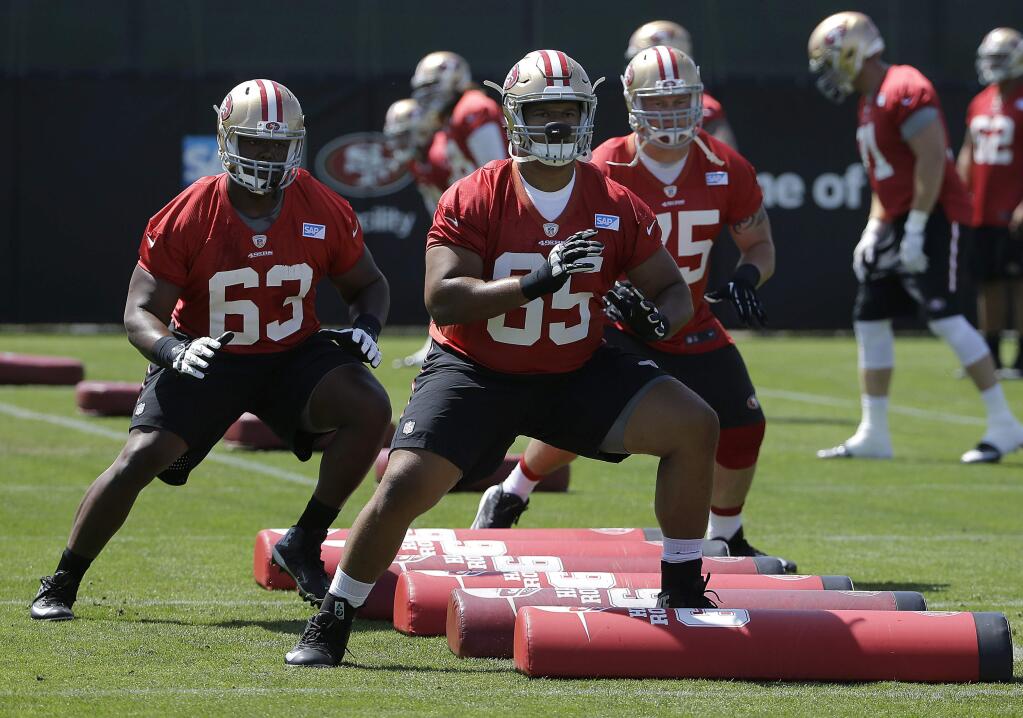 San Francisco 49ers offensive linemen Norman Price (63), Joshua Garnett (65) and Colin Kelly perform a drill during practice Wednesday, June 8, 2016. (AP Photo/Jeff Chiu)