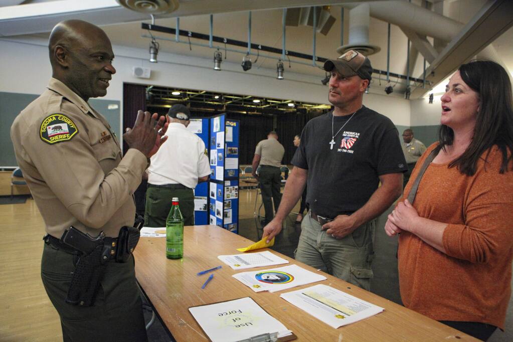 Petaluma, CA, USA._Thursday, April 25, 2019. Captain Eddie Engram talks with Stephanie and William Dobbs during a town hall informational meeting with the public last week at the Petaluma Recreation Center. (CRISSY PASCUAL/ARGUS-COURIER STAFF)