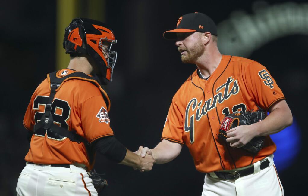 San Francisco Giants' Will Smith, right, and Buster Posey celebrate the team's 3-2 win over the St. Louis Cardinals in a baseball game Friday, July 6, 2018, in San Francisco. (AP Photo/Ben Margot)