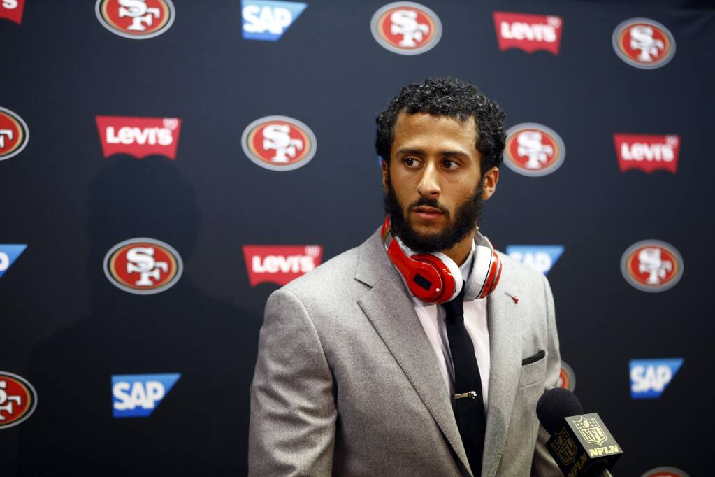 Colin Kaepernick talks to reporters after the loss to the St. Louis Rams on Nov. 1. He was benched the next day as the 49ers' starting quarterback. (Billy Hurst / Associated Press)