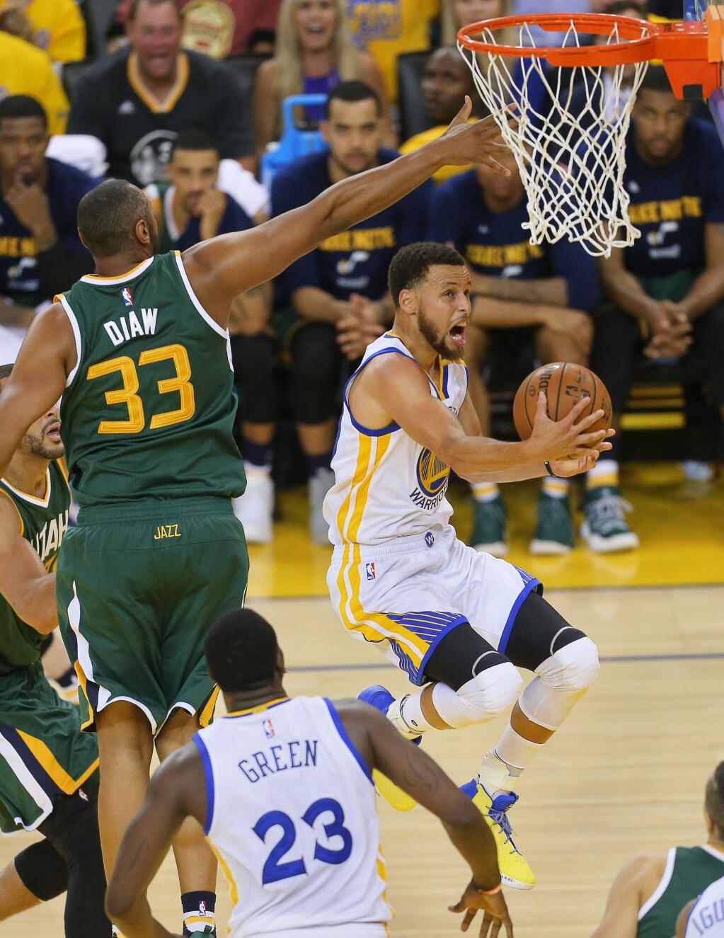 Golden State Warriors guard Stephen Curry scoops the ball up and in against Utah Jazz center Boris Diaw, during Game 1 of the of NBA Western Conference Semifinals in Oakland on Tuesday, May 2, 2017. (Christopher Chung/ The Press Democrat)