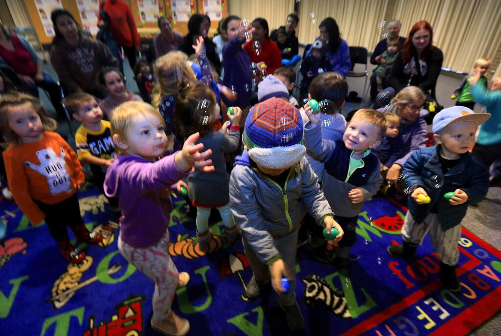 Children play at the Sonoma County Central Library in Santa Rosa. Thanks to funds from Measure Y, library hours are expanding. (John Burgess/The Press Democrat)