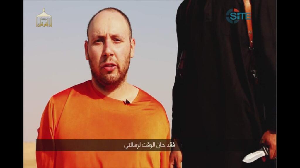 This image made from video posted on the Internet by Islamic State militants purports to show journalist Steven Sotloff before he was beheaded. The Arabic text at the bottom of the frame translates to 'Now is the time for my message.' (ASSOCIATED PRESS)