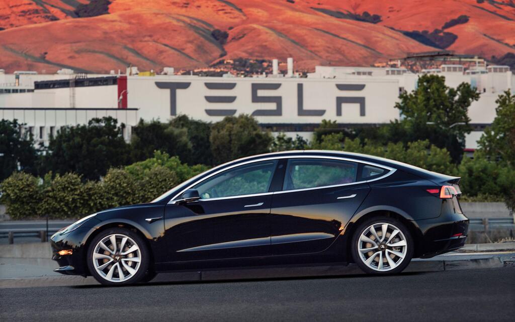 This undated image provided by Tesla Motors shows the Tesla Model 3 sedan. The electric car company's newest vehicle, the Model 3, which set to go to its first 30 customers Friday, July 28, 2017, is half the cost of previous models. Its $35,000 starting price and 215-mile range could bring hundreds of thousands of customers into Tesla's fold, taking it from a niche luxury brand to the mainstream. (Courtesy of Tesla Motors via AP)