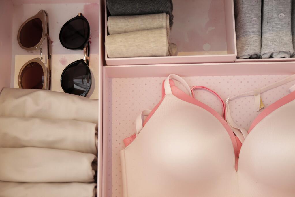 In this July 11, 2018 photo, storage boxes filled with clothing and sunglasses are displayed at a media event for Japanese organizational expert Marie Kondo in New York. (AP Photo/Seth Wenig)