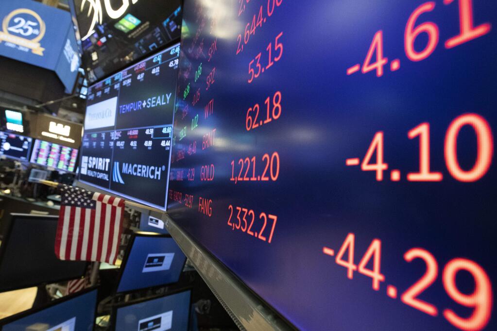 Stock screens are displayed, Tuesday, Nov. 20, 2018, at the New York Stock Exchange. Stocks are skidding Tuesday as weak results from retailers and mounting losses for big technology companies push the market back into the red for the year. (AP Photo/Mark Lennihan)