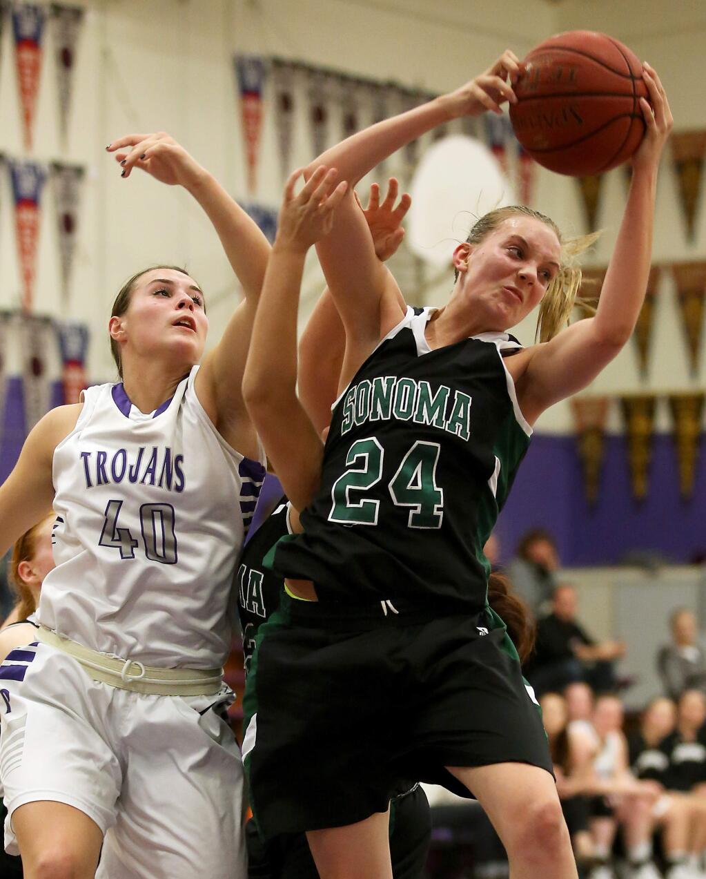 Sonoma Valley's Renee O'Donnell, right, comes down with the rebound against Petaluma's Joelle Krist during the game held at Petaluma High School, Tuesday, January 27, 2015. (Crista Jeremiason / The Press Democrat)