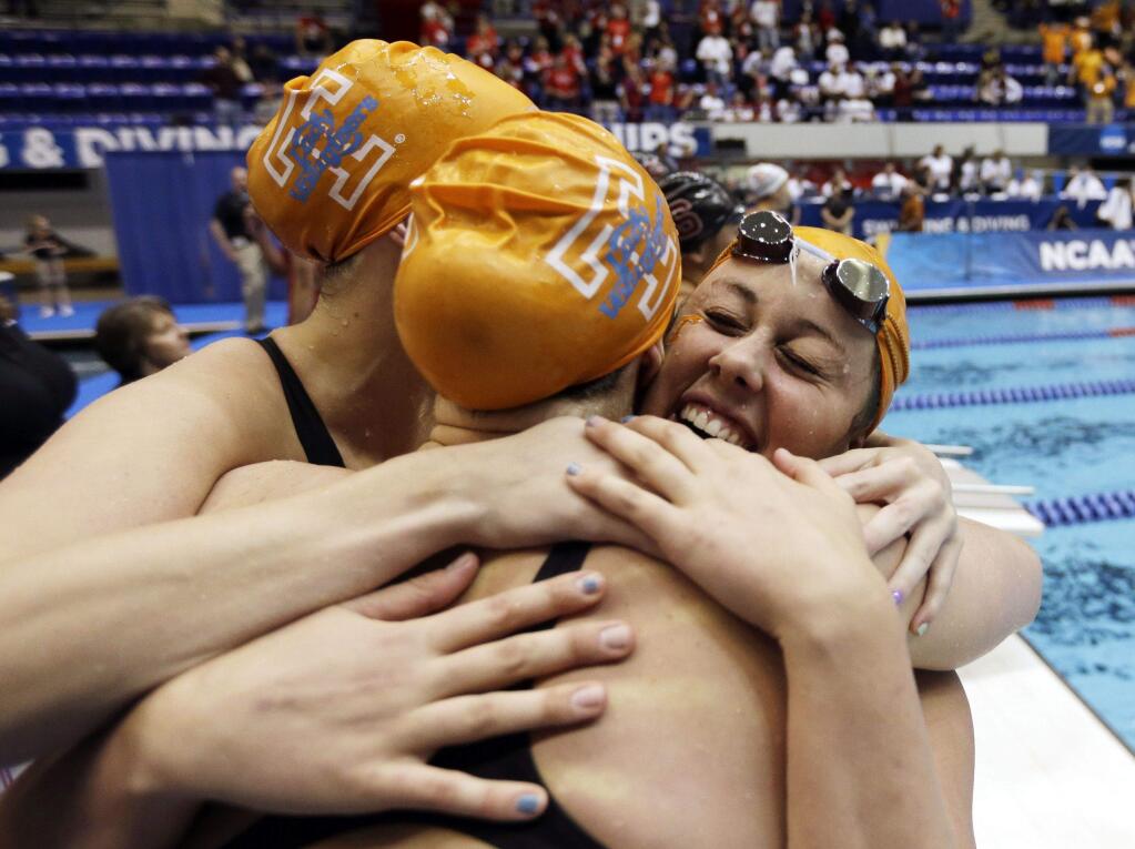 Molly Hannis, right, celebrates with University of Tennessee teammates after a medley relay victory at the NCAA championship meet. (Darron Cummings / Associated Press)