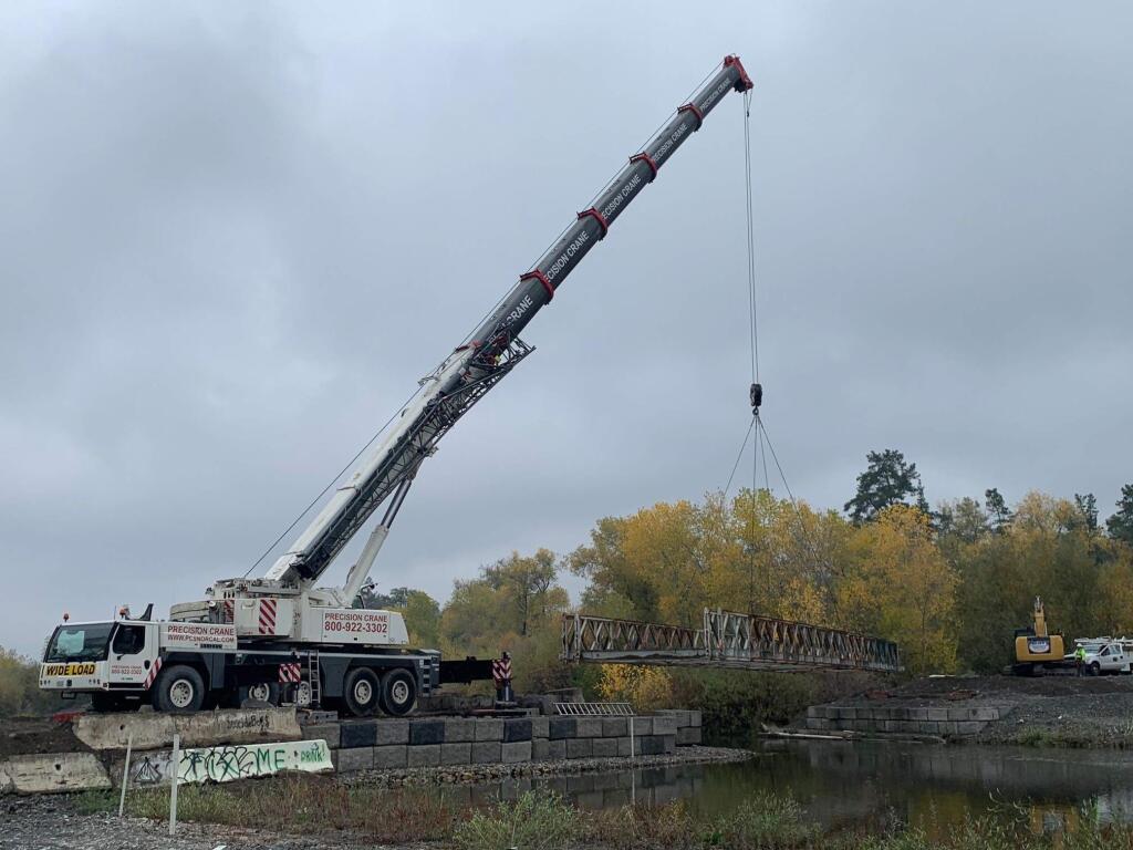 Sonoma County Transportation and Public Works Department crews worked to quickly remove a 100-foot temporary bridge at Asti, just south of Cloverdale, for the wet season, on Thursday, Dec. 5, 2019. (County of Sonoma)