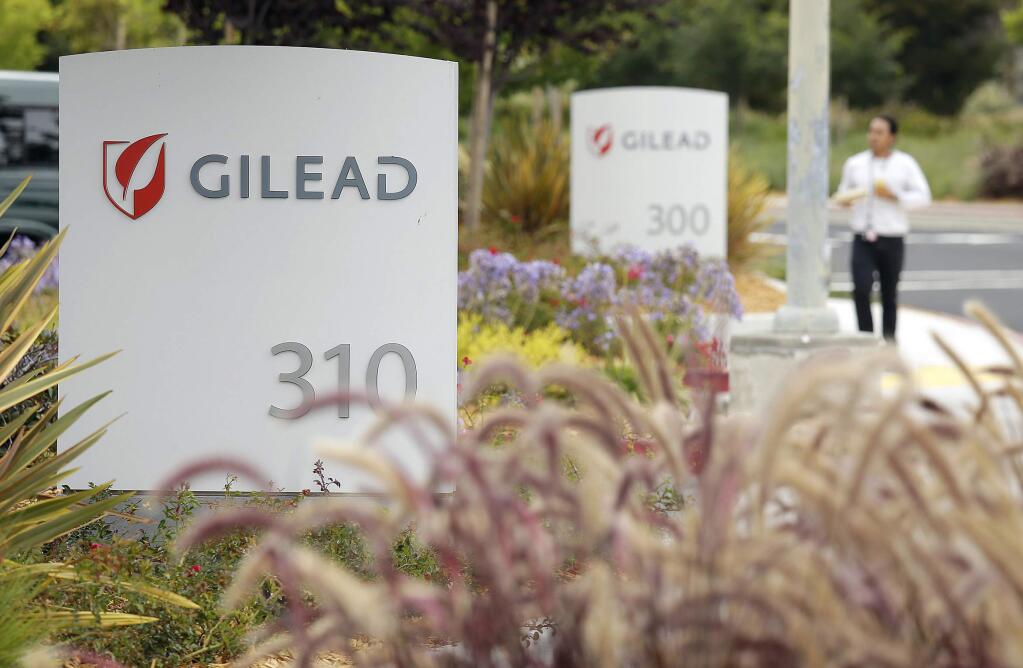 FILE - In this July 9, 2015, file photo, a man walks outside the headquarters of Gilead Sciences in Foster City, Calif. Gilead, the pharmaceutical giant that makes remdesivir, a promising coronavirus drug, has registered it as a rare disease treatment with U.S. regulators on Monday, March 23, 2020, a status that can potentially be worth millions in tax breaks and competition-free sales. (AP Photo/Eric Risberg, File)