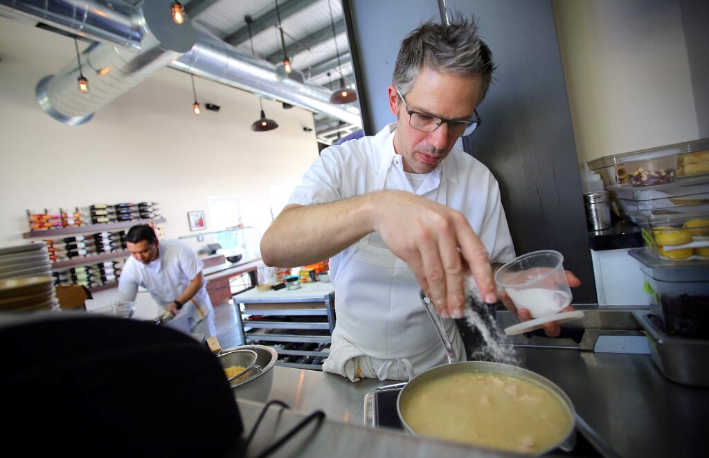 PHOTO: 3 BY CHRISTOPHER CHUNG/ THE PRESS DEMOCRAT -Mark Hopper, owner and chef at Vignette Pizzeria in Sebastopol, adds a bit of salt to the casserole he made from goods in an earthquake kit during a mock Iron Chef challenge held in light of the August Napa quake.