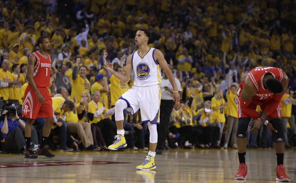 Golden State Warriors' Stephen Curry, center, celebrates between Houston Rockets' Dwight Howard, right, and Trevor Ariza after a score during the first quarter of Game 1 of the NBA basketball Western Conference finals Tuesday, May 19, 2015, in Oakland, Calif. (AP Photo/Ben Margot)