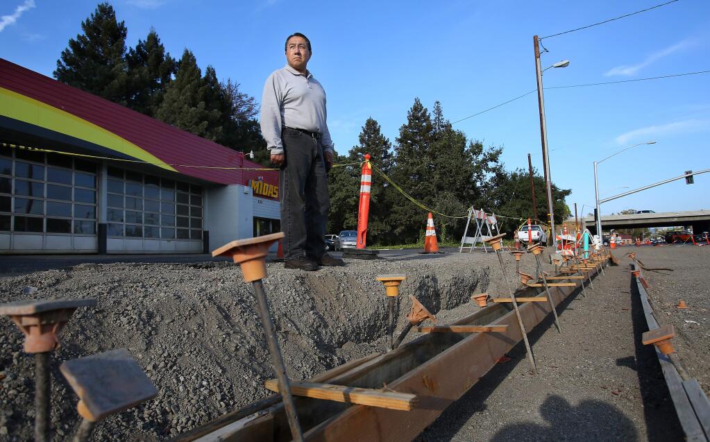 Ed Gasca, owner of the Midas station in Santa Rosa, is concerned about the construction work in front of his business on College Avenue. The height of the roadway is noticeably lower than the parking lot for his business. (CHRISTOPHER CHUNG/ PD FILE, 2014)