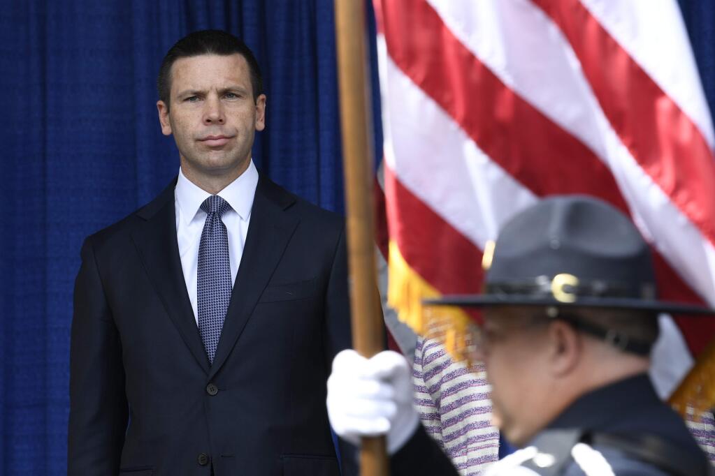 Acting Secretary of Homeland Security Kevin McAleenan watches as the color guard arrives for a ribbon cutting ceremony for the Department of Homeland Security's St. Elizabeths Campus Center Building in Washington, Friday, June 21, 2019. (AP Photo/Susan Walsh)