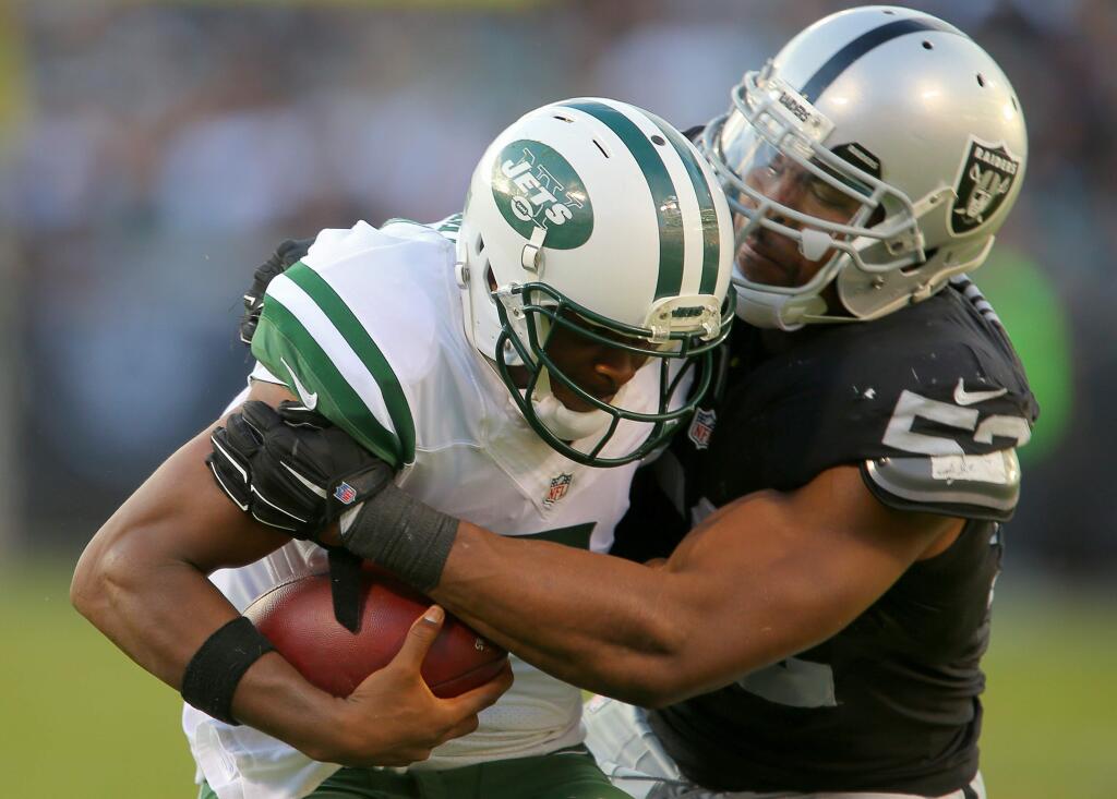Oakland Raiders defensive Khalil Mack sacks New York Jets quarterback Geno Smith, in the fourth quarter during their game in Oakland on Sunday, November 1, 2015. The Raiders defeated the Jets 34-20. (Christopher Chung/ The Press Democrat)