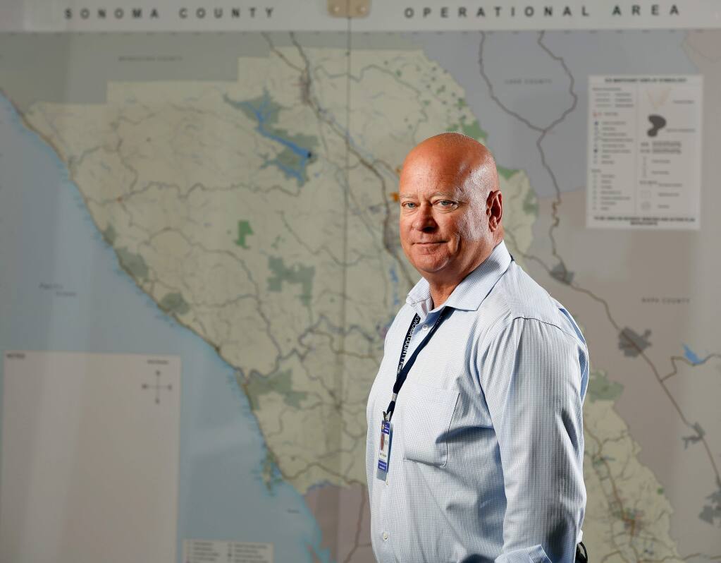 Jim Colangelo, interim director of Sonoma County Fire and Emergency Services, poses for a portrait in front of an operational area map of Sonoma County, at the department's office in Santa Rosa, California, on Tuesday, August 1, 2017. (Alvin Jornada / The Press Democrat)