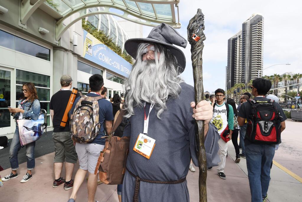 Randall Cheatwood, dressed as the character Gandalf from 'The Hobbit' and 'The Lord of the Rings,' series, walks in front of the convention center on the first day of the 2015 Comic-Con International at the San Diego Convention Center, Thursday, July 9, 2015, in San Diego. Comic-Con runs July 9-12. (Photo by Denis Poroy/Invision/AP)