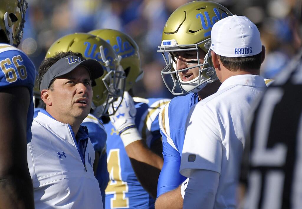 This photo taken Oct. 21, 2017, shows UCLA offensive coordinator Jedd Fisch, left, talking with quarterback Josh Rosen, center, and head coach Jim Mora during the second half against Oregon in Pasadena. (AP Photo/Mark J. Terrill)