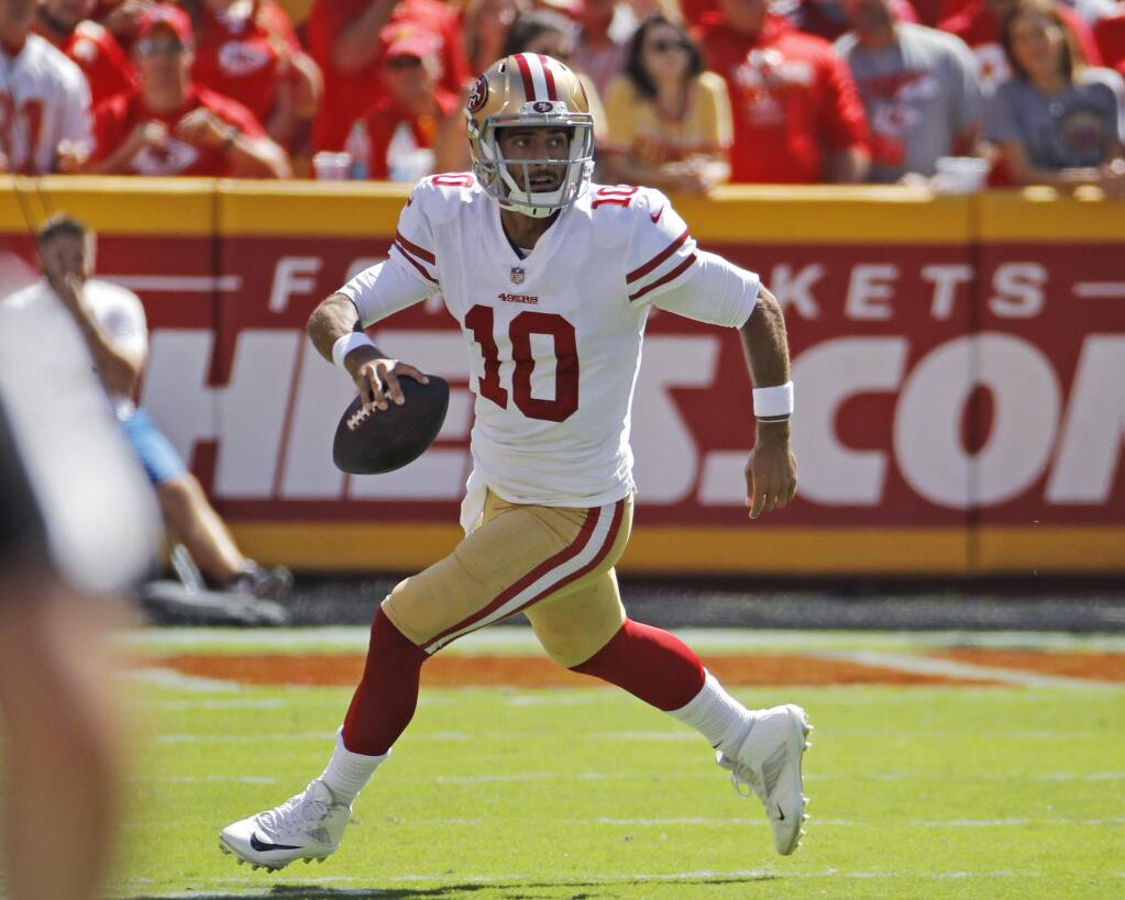 In this Sept. 23, 2018, file photo, San Francisco 49ers quarterback Jimmy Garoppolo runs with the ball during the first half against the Kansas City Chiefs in Kansas City, Mo. Garoppolo has resumed throwing and taking drop backs as he rehabilitates from a major knee injury that derailed his first full season as San Francisco's starting quarterback. (AP Photo/Charlie Riedel, File)
