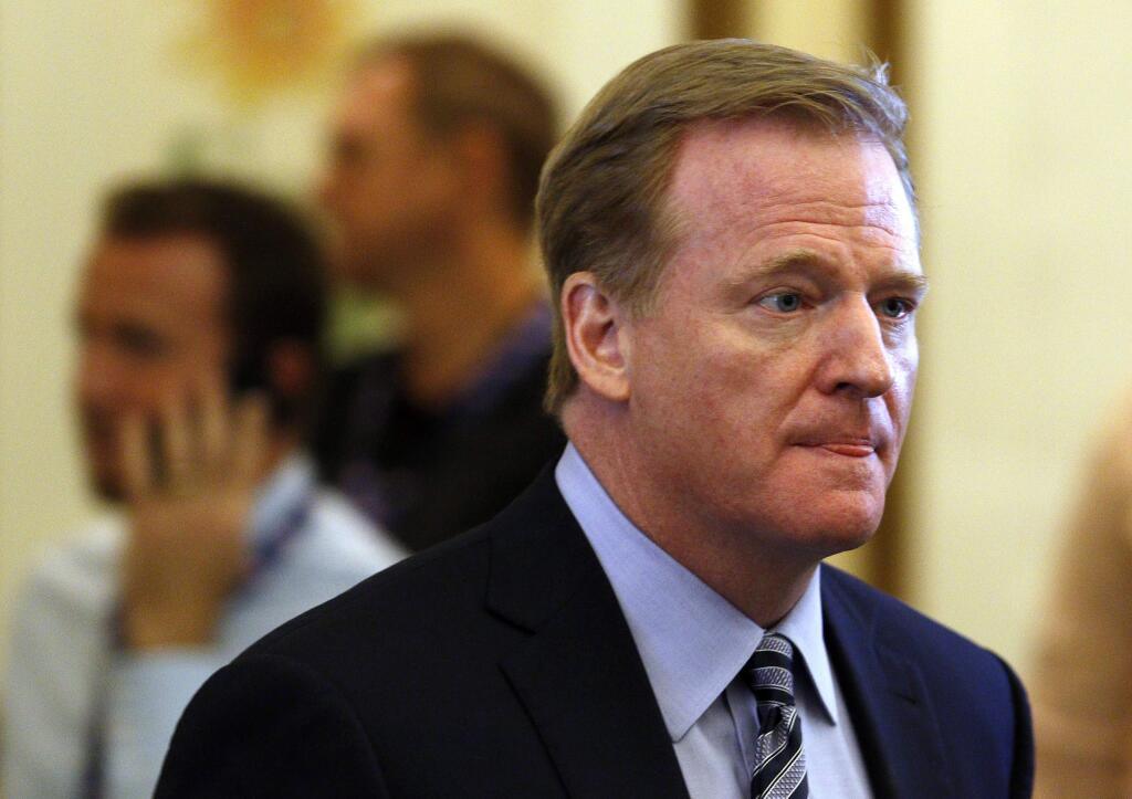 FILE - In this Tuesday, May 24, 2016, file phot, NFL commissioner Roger Goodell makes his way into the NFL owner's meeting in Charlotte N.C. Goodell reaffirmed the league's commitment to concussion research in a letter Thursday, May 26, 2016, to the 32 team owners. (AP Photo/Bob Leverone, File)