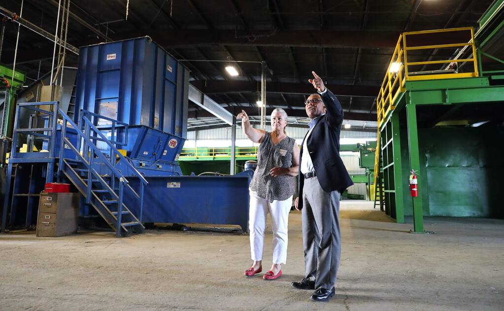 Ratto Group recycle outreach coordinator Lisa Moore, left, gives Rohnert Park councilmember Amy O. Ahanotu a tour of their remodeled recycling facility in Santa Rosa on Wednesday, August 2, 2017. (Christopher Chung/ The Press Democrat)