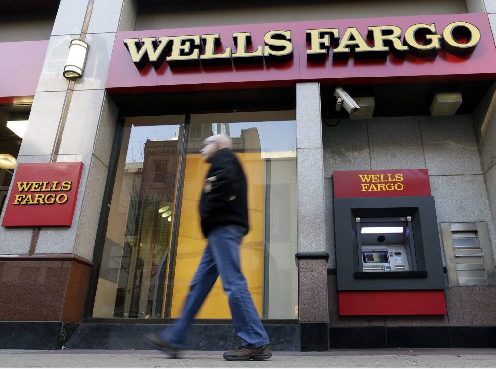 A man walks past a Wells Fargo branch in Philadelphia on Dec. 19, 2012. (Matt Rourke / Associated Press)