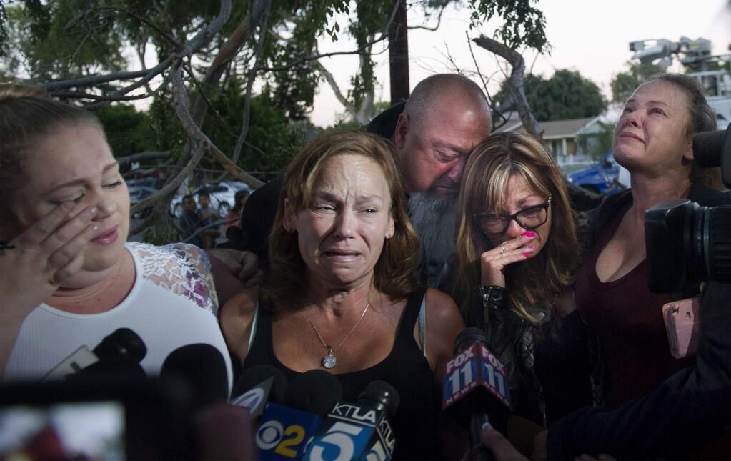 Arthur William Boucher's friends and family members, from left, Karissa Derhovanisian, Kimberly Frazier, the mother of Boucher, Salvador and Cheryl Mineo, Boucher's uncle and aunt, and Joyce Buchett speak before reporters as they attended a candlelight vigil in Fullerton, Calif., Sunday, Sept. 25, 2016. The vigil took place at a Southern California home where Boucher and two others were found dead over the weekend. (Cindy Yamanaka/The Orange County Register via AP) 's family and girlfriend remember 'Billy,' who was murdered at his friend's Fullerton home.