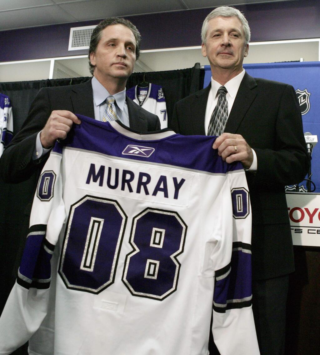 Los Angeles Kings general manager Dean Lombardi, left, and the NHL hockey team's new coach, Terry Murray, hold up a jersey with Murray's name Thursday, July 17, 2008, at their training facility in El Segundo, Calif. (AP Photo/Ric Francis)