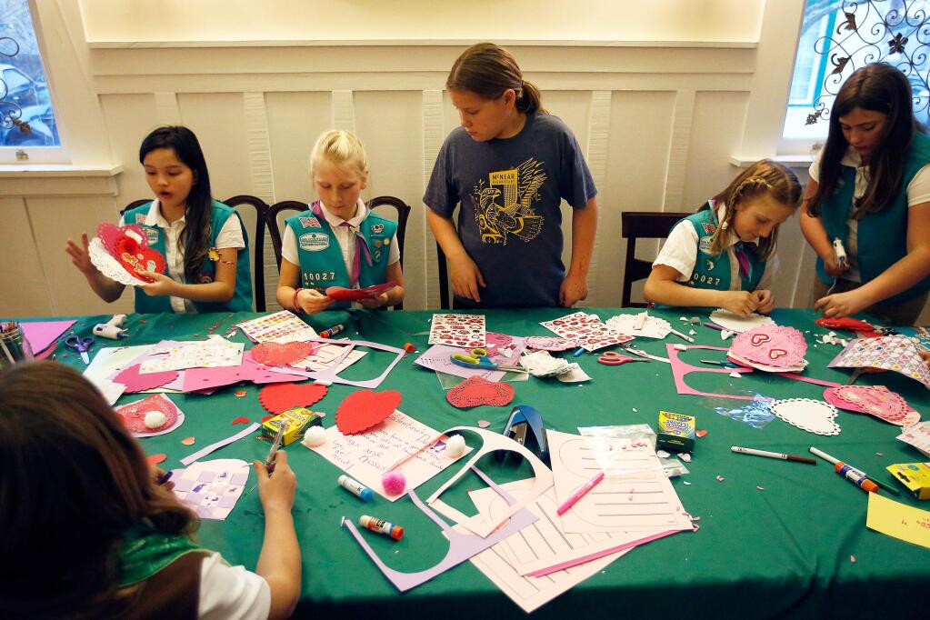 Girl Scout juniors of Troop 10027, from left, Lennon Pagliaro-Smith, 10, Audrey Morgan, 9, Elisabeth Frank, 10, Brynn Morgan, 10, and Story Lewis, 10, make Valentine's day cards that will be delivered to the elderly by Petaluma People Services, in Petaluma, California, on Wednesday, January 31, 2018. (Alvin Jornada / The Press Democrat)