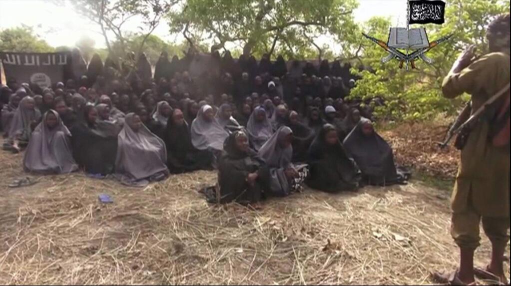 FILE - This Monday, May 12, 2014 file image taken from video by Nigeria's Islamic extremist network, shows the alleged missing girls abducted from the northeastern town of Chibok. An unknown number of girls kidnapped from their Nigerian boarding school by jihadists three years ago have been released, a government official said Saturday, May 6, 2017. Family members said they were awaiting names and other information before celebrating. (AP Photo/File)