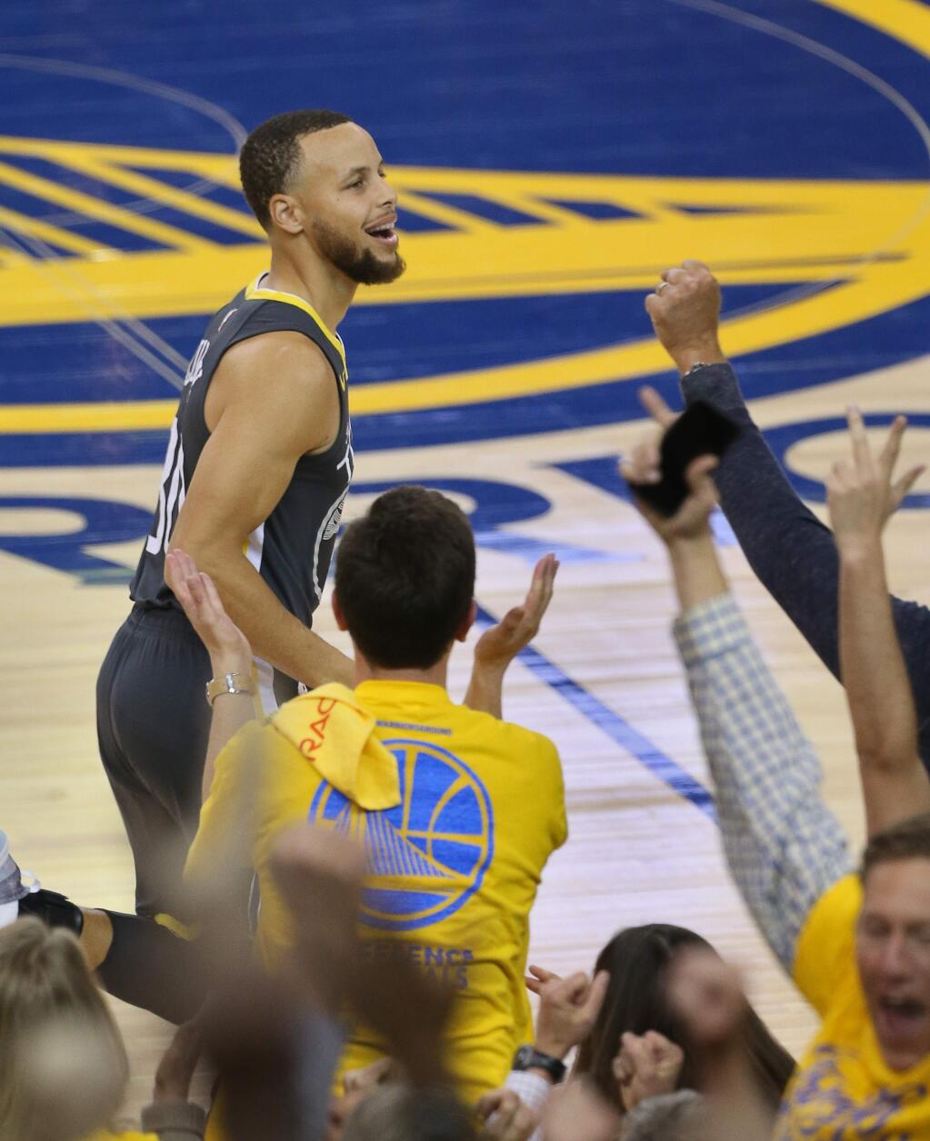 Golden State Warriors guard Stephen Curry celebrates his first three-pointer since coming back from injury against the New Orleans Pelicans, during their game in Oakland on Tuesday, May 1, 2018. (Christopher Chung / The Press Democrat)