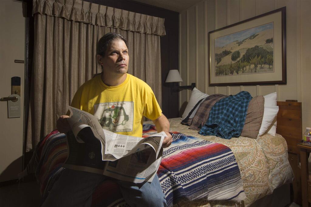 Nick Brown waits in his room at the El Pueblo Inn in Sonoma for news of when he can return to his Glen Ellen home that was destroyed in the recent firestorm. One of the few personal items he managed to grab before he fled from the flames was a blanket he's had since his college days. (Photo by Robbi Pengelly/index-Tribune)